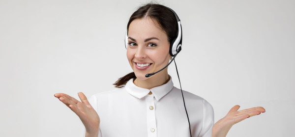 a smiling customer service woman wearing headphones with a microphone